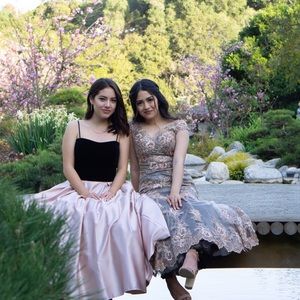 Selling the black and blush pink gown (left)